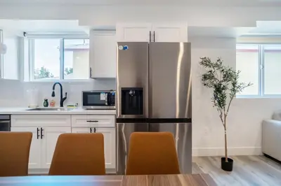 a kitchen with a stainless steel refrigerator at Stylish & Cozy Retreat Near USC & Downtown LA in Los Angeles