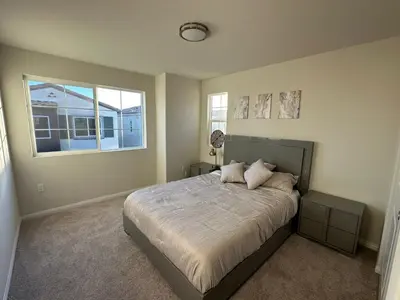 a bedroom with a large bed and a window at 3 bed 3 Bath Gated Corner unit in Upland