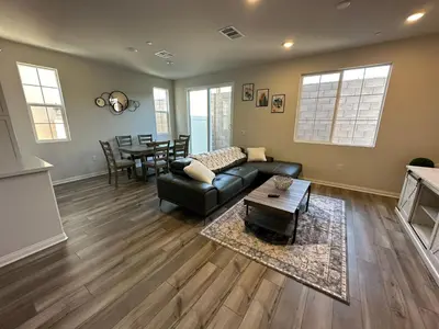 a living room with a couch and a table at 3 bed 3 Bath Gated Corner unit in Upland