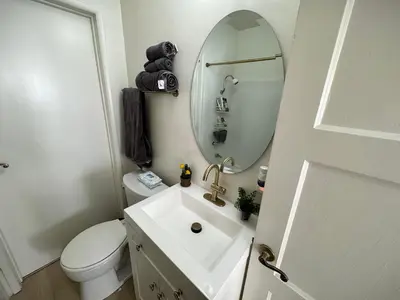 a bathroom with a sink and a mirror and a toilet at gateway to the ocean in Hawthorne