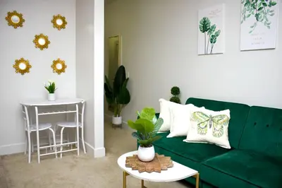 a living room with a green couch and a table at Studio Luxury Marina del Rey with parking gym pool in Los Angeles