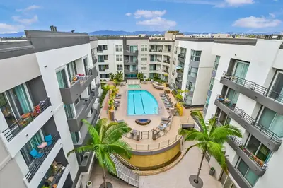 an overhead view of an apartment complex with a pool and palm trees at Studio Luxury Marina del Rey with parking gym pool in Los Angeles