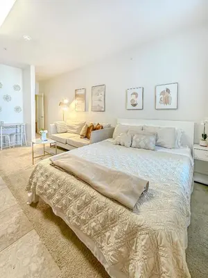 a white bedroom with a large bed and a couch at Studio Luxury Marina del Rey with parking gym pool in Los Angeles