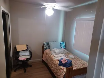 a small bedroom with a bed and a ceiling fan at 2bd Home Lomita California spectacular location in Lomita