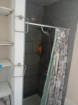 a shower with a shower curtain in a bathroom at Handcraft Cabin LAX Port of LA 20 min away in Lomita