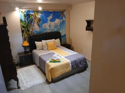 a bedroom with a bed and a painting on the wall at Handcraft Cabin LAX Port of LA 20 min away in Lomita
