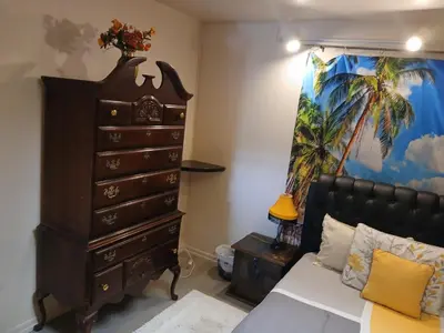 a bedroom with a dresser and a bed in a room at Handcraft Cabin LAX Port of LA 20 min away in Lomita