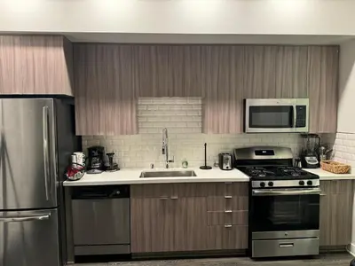 a kitchen with a sink and a stove and a microwave at Vibrant unit in Griffith in Glendale