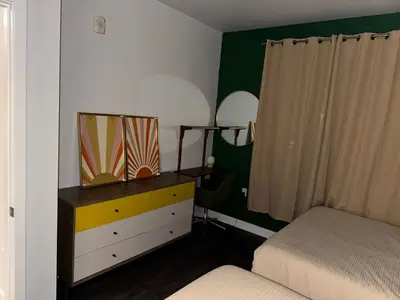 a bedroom with a bed and a dresser with a mirror at Vibrant unit in Griffith in Glendale