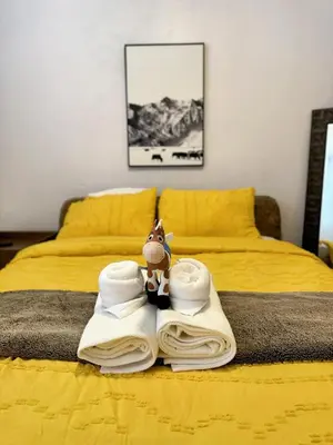 a bed with towels and a toy on top of it at Modern & Spacious Family and Friend 4B3B House in Moreno Valley