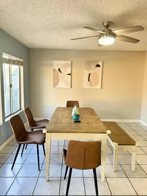 a dining room with a wooden table and chairs at Modern & Spacious Family and Friend 4B3B House in Moreno Valley