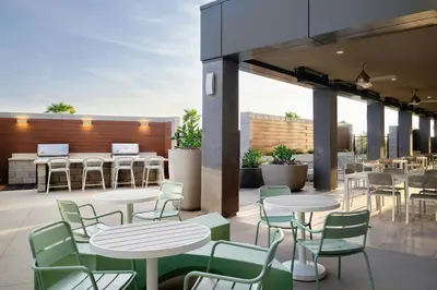 a patio with tables and chairs and tables and tables and chairs at TownePlace Suites by Marriott Ventura Oxnard in Oxnard