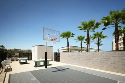 a basketball hoop on a wall with palm trees at TownePlace Suites by Marriott Ventura Oxnard in Oxnard