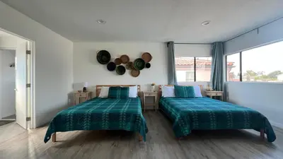 a bedroom with two beds with green sheets and a window at Spacious 3BR 3BA Home Private Yard in Culver City in Los Angeles