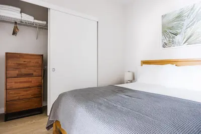 a bedroom with a large bed and a closet at Blueground Downtown elevator nr parks LAX-1235 in Los Angeles