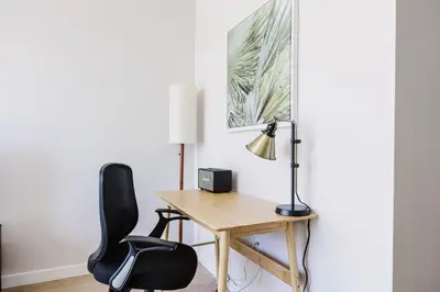 a desk with a lamp and two chairs in a room at Blueground Downtown elevator nr parks LAX-1235 in Los Angeles