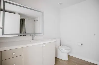a white bathroom with a sink and a toilet at Blueground Downtown elevator nr The Broad LAX-1236 in Los Angeles