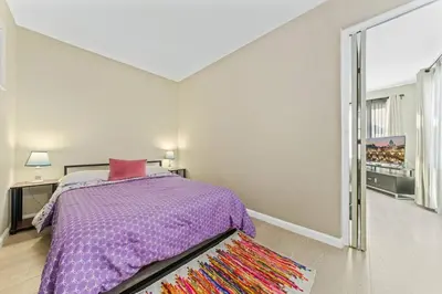 a bedroom with a bed and a large window at Comfy 2 BR House near LAX, SOFI and Intuit Dome! in Inglewood