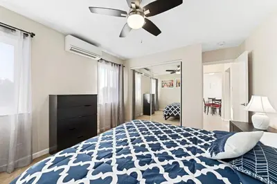 a bedroom with a bed and a ceiling fan at Comfy 2 BR House near LAX, SOFI and Intuit Dome! in Inglewood