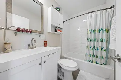 a white bathroom with a toilet and a sink at Comfy 2 BR House near LAX, SOFI and Intuit Dome! in Inglewood
