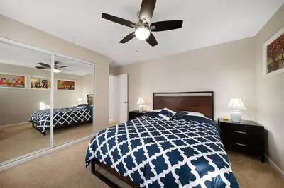 a bedroom with a bed and a ceiling fan at Comfy 2 BR House near LAX, SOFI and Intuit Dome! in Inglewood