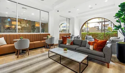 a lobby with a couch and chairs and a table at Surfs up! Cozy 1 Bedroom Condo with Fountain View in Los Angeles