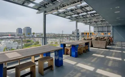 a large room with tables and chairs on a building at Modern Venice Beach Stay - Walk to Marina & Boardwalk in Los Angeles