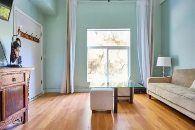 a living room with a couch and a glass table at Malibu Home in Enchanting Hills 5 min from the beach in Malibu
