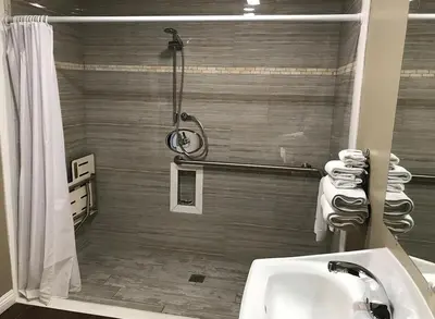 a bathroom with a shower and a sink at Corona inn in Corona