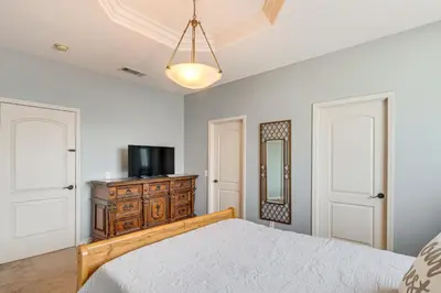 a bedroom with a bed and a television on a dresser at 6 Mi to Dtwn Pasadena Home with Patio and Yard! in San Gabriel