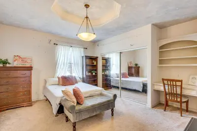 a bedroom with a bed and a chair and a mirror at 6 Mi to Dtwn Pasadena Home with Patio and Yard! in San Gabriel
