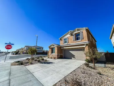 a house on a street with a stop sign at California 3-Bedroom Desert Escape With Garden in Victorville