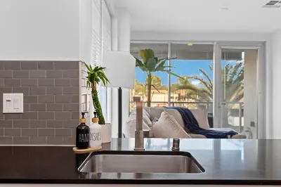 a kitchen with a sink and a living room at The rose-Spacious 3-Bedroom Retreat in the Heart of Marina del Rey in Los Angeles