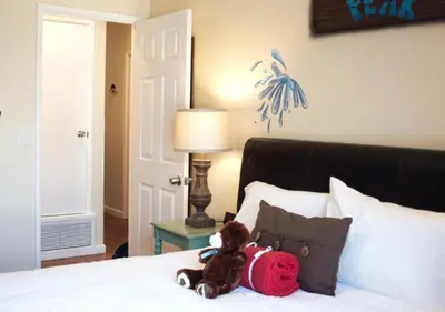 a teddy bear sitting on top of a bed at MagicwayVillas Paradise Pier Home - Across Disney in Anaheim