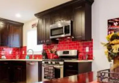 a kitchen with red tile on the walls at MagicwayVillas Cars Theme Pool House - Pool&Spa in Anaheim