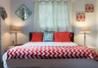 a bedroom with a red and white bed with two lamps at MagicwayVillas Cars Theme Pool House - Pool&Spa in Anaheim