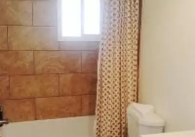 a bathroom with a tub and a window and a shower curtain at MagicwayVillas Cars Theme Pool House - Pool&Spa in Anaheim