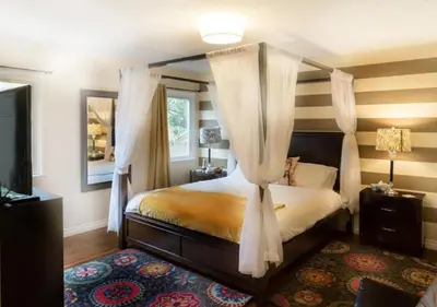 a bedroom with a canopy bed and a large mirror at MagicwayVillas LionQueen - Pool and Spa in Anaheim