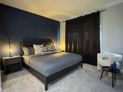 a bedroom with a bed and a black wall at Bright & Spacious in Iconic LA Neighborhood Free parking - 10mins to Cedars in Los Angeles