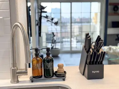 a kitchen counter with two bottles of wine next to a sink at Bright & Spacious in Iconic LA Neighborhood Free parking - 10mins to Cedars in Los Angeles