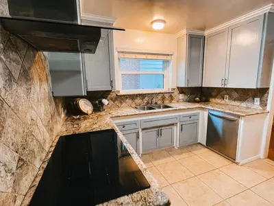 a kitchen with white cabinets and a sink at Cozy 4BR home near SoFi in the City Of Champions in Inglewood