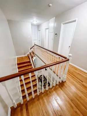 an empty room with a staircase with wooden floors at Cozy 4BR home near SoFi in the City Of Champions in Inglewood
