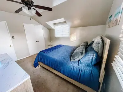 a bedroom with a bed and a ceiling fan at Cozy 4BR home near SoFi in the City Of Champions in Inglewood