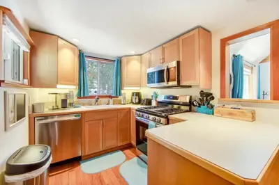 a kitchen with wooden cabinets and a white counter top at Calm Cozy 3BR cabin wAC, WiFi, Parking, BBQ in Cedar Glen