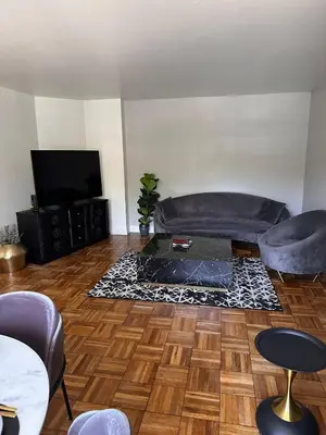 a living room with a couch and a television at Warm and Welcoming in Los Angeles