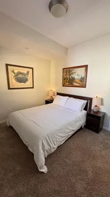 a bedroom with a large bed with white sheets and pillows at Private Room and Bathroom in Los Angeles
