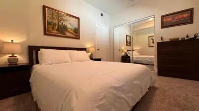 a bedroom with a large white bed and a mirror at Private Room and Bathroom in Los Angeles