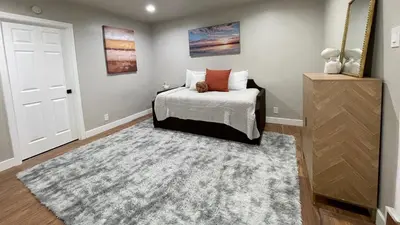 a bedroom with a bed and a rug at Stylish & Cozy Retreat in the Heart of LA in Los Angeles
