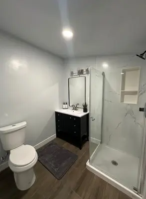 a bathroom with a toilet and a shower and a sink at Stylish & Cozy Retreat in the Heart of LA in Los Angeles