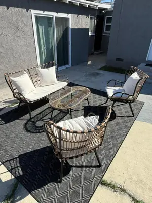 a patio with two chairs and a table and chairs at Stylish & Cozy Retreat in the Heart of LA in Los Angeles